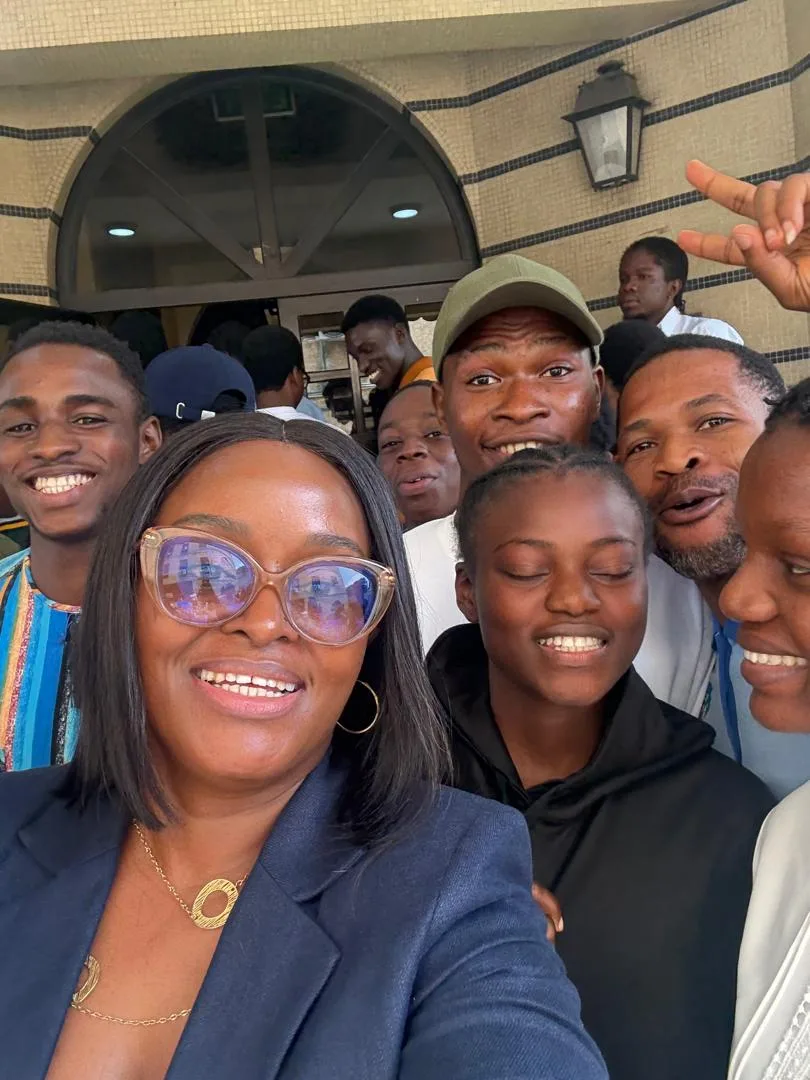 Group selfie of masterclass participants outdoors, with Sowari Akosionu in the foreground